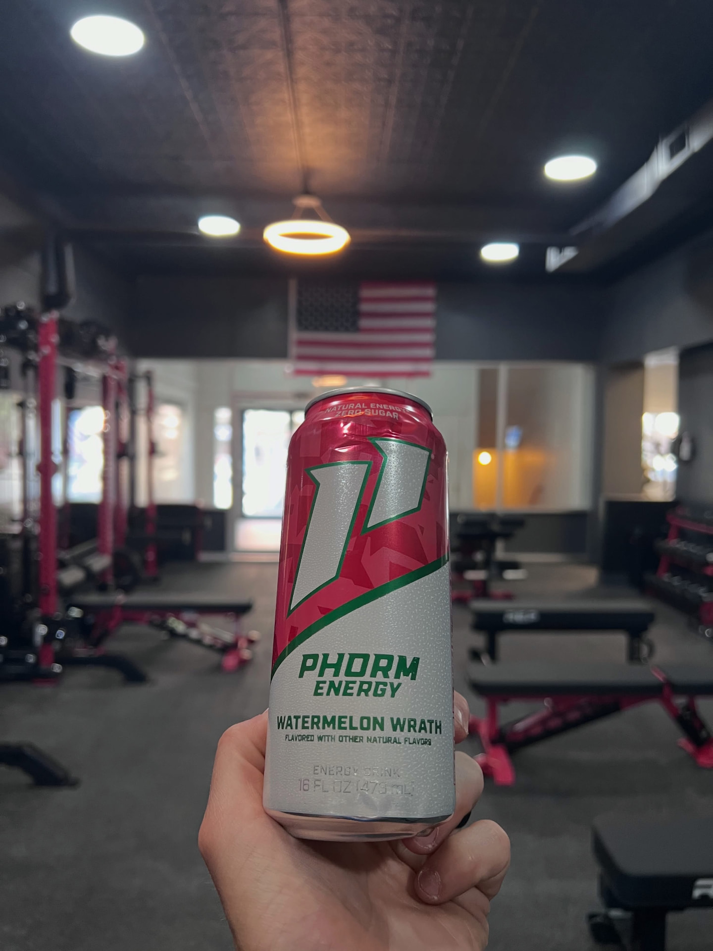 Cold Phorm Energy can held up on the gym floor