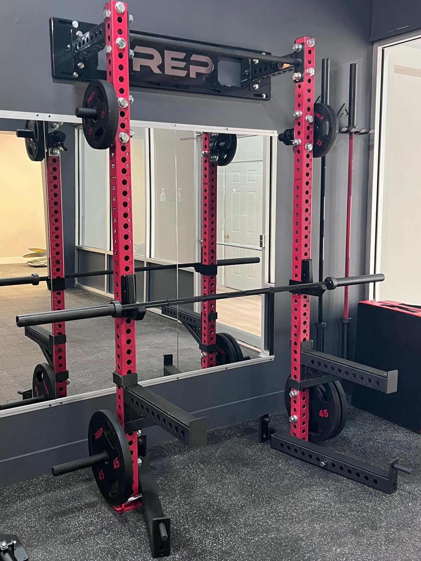 Squat rack with barbells and weight plates
