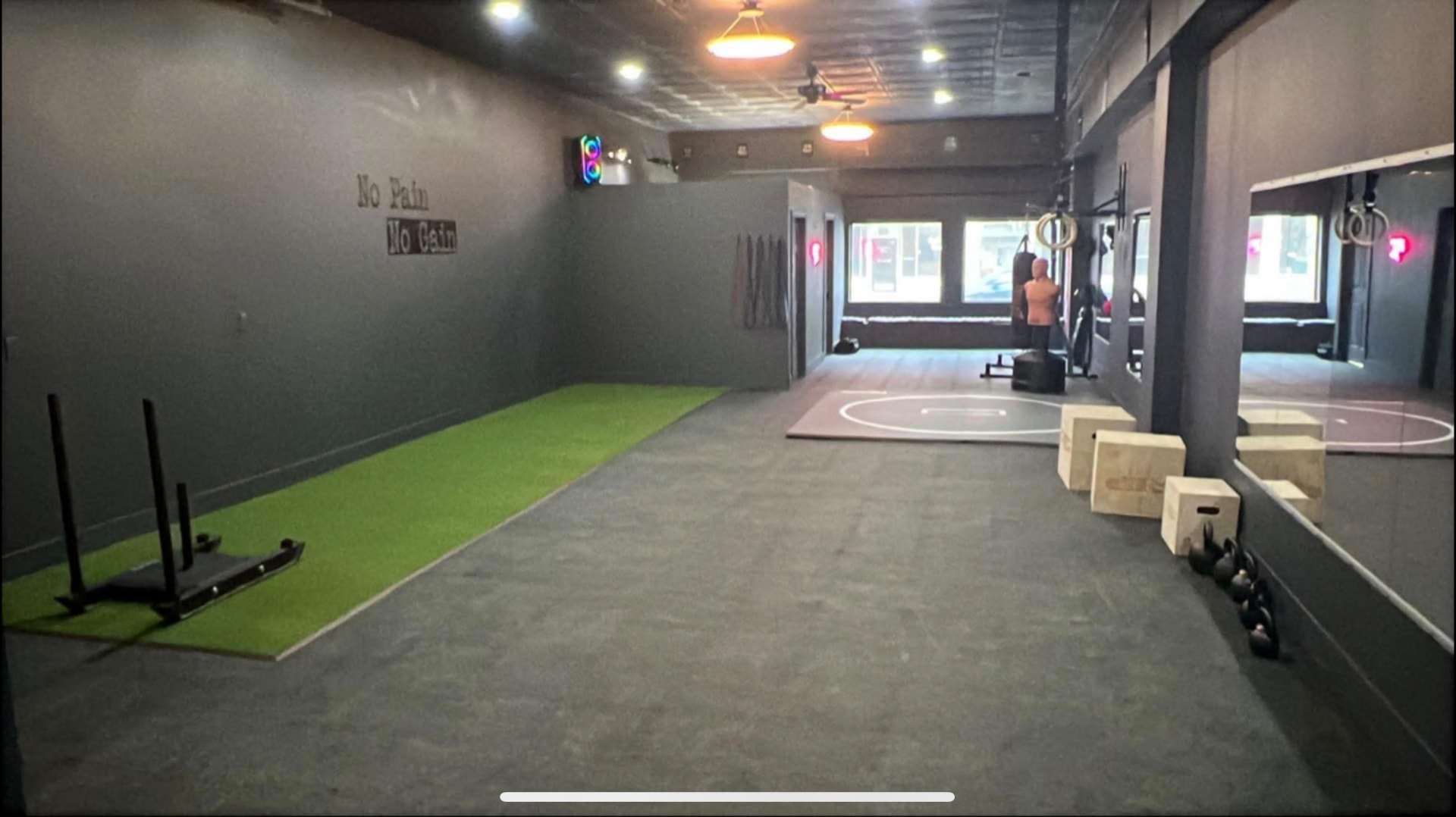 Open turf and functional training area with sled, plyo boxes and heavy bag